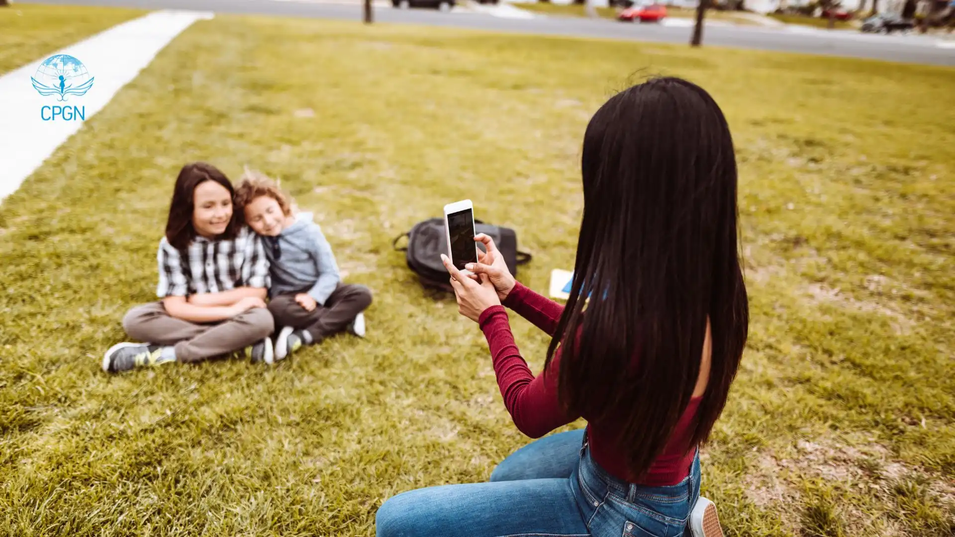 mom taking picture of children on mobile